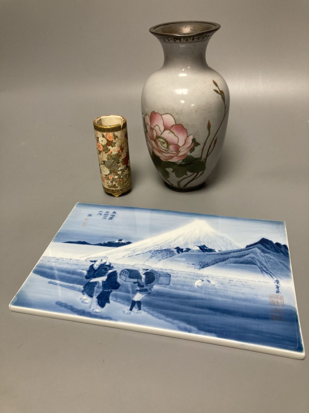A Japanese satsuma brush pot (a.f.), a similar cloisonne vase and a porcelain tile, tallest 18cm